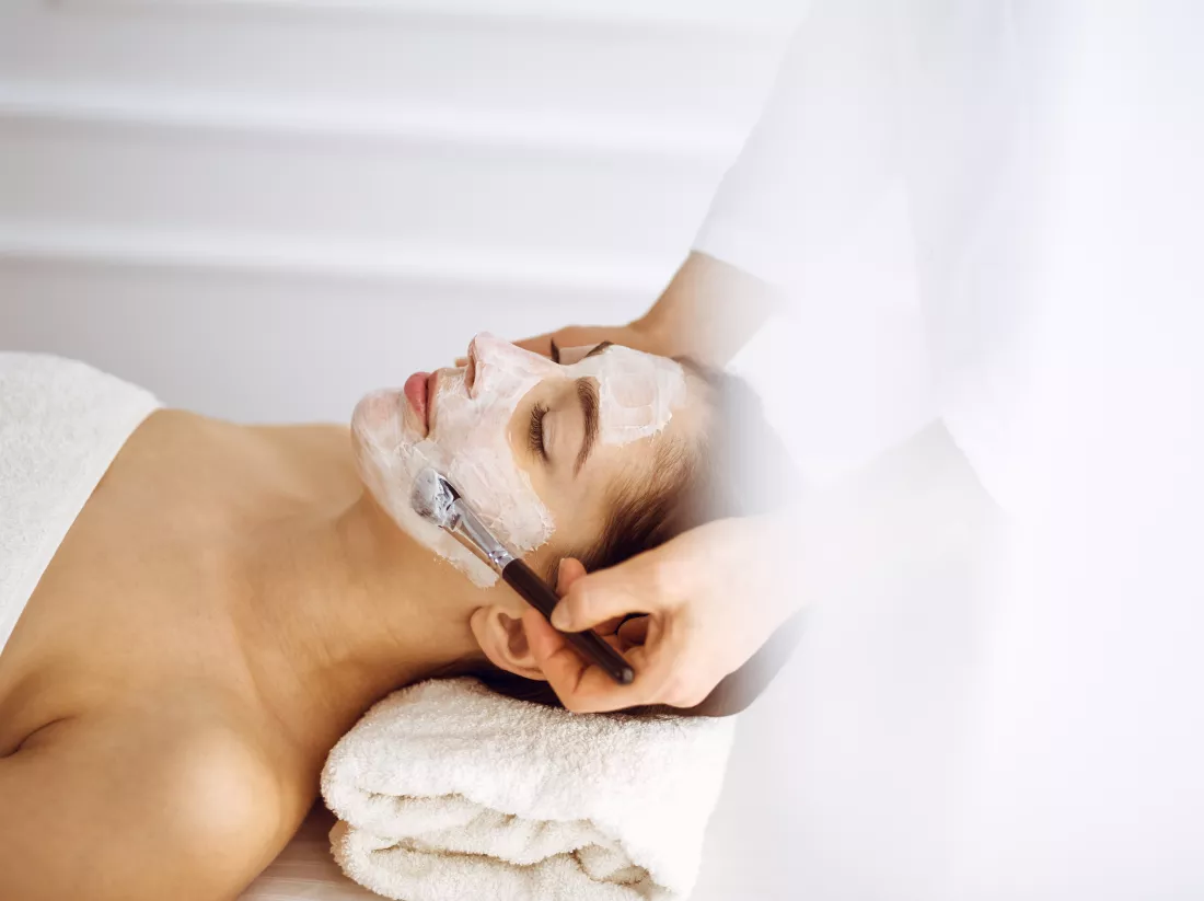 beautiful-brunette-woman-enjoying-applying-cosmetic-mask-with-closed-eyes-relaxing-treatment-medicine-spa-center-concepts