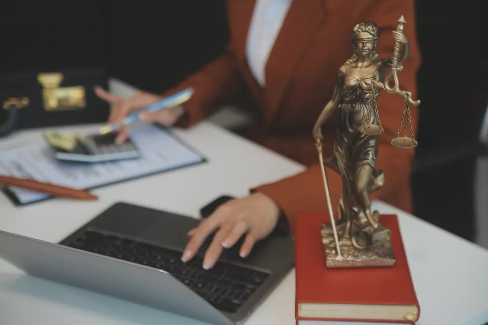 american-woman-lawyer-businesswoman-african-working-with-laptop-searching-analyzing-data-reading-contract-documents-work-with-law-books-hammer-justice-consulting-lawyer-concept