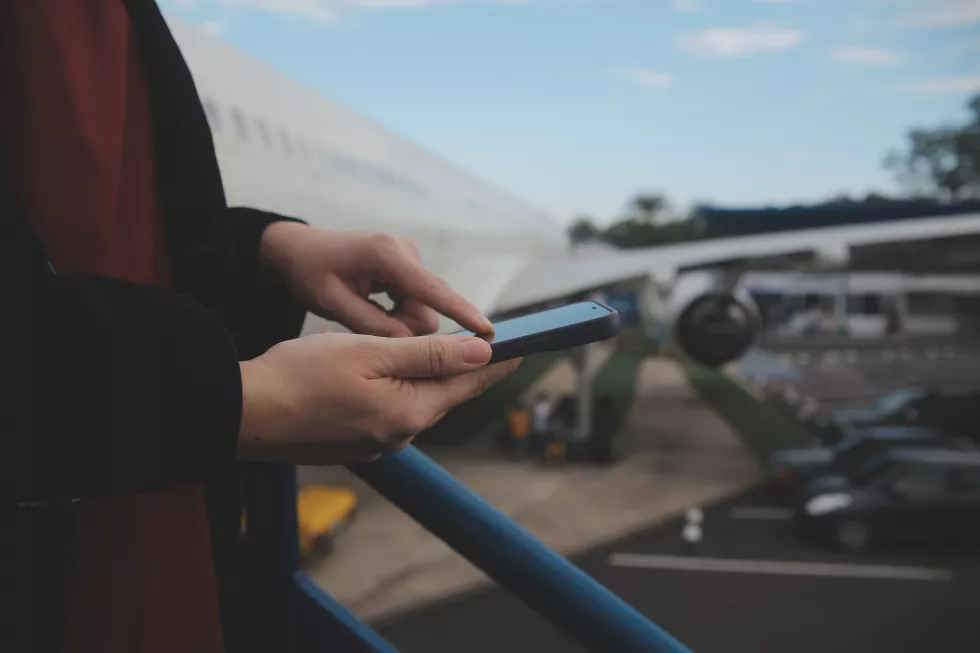 young-asian-woman-international-airport-using-mobile-smartphone-checking-flight-flight-information-board
