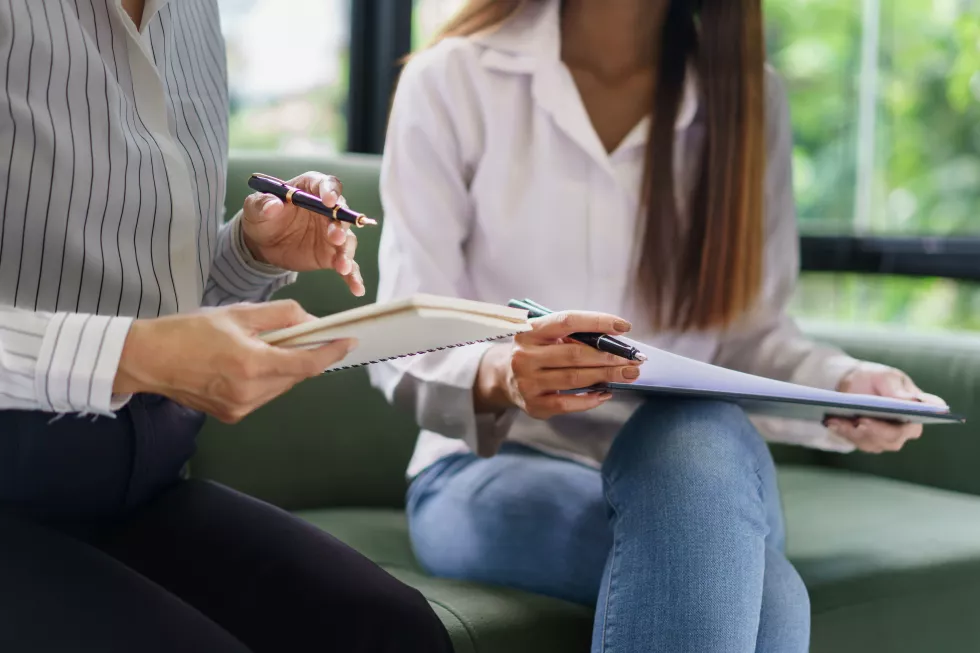coworker-business-concept-two-businesswoman-discussing-about-chart-financial-taking-notes-data