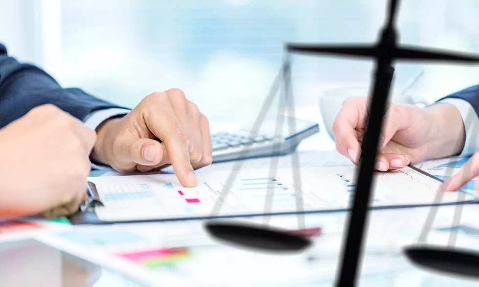 businesspeople-lawyers-discussing-contract-papers-with-brass-scale-wooden-desk-office-law