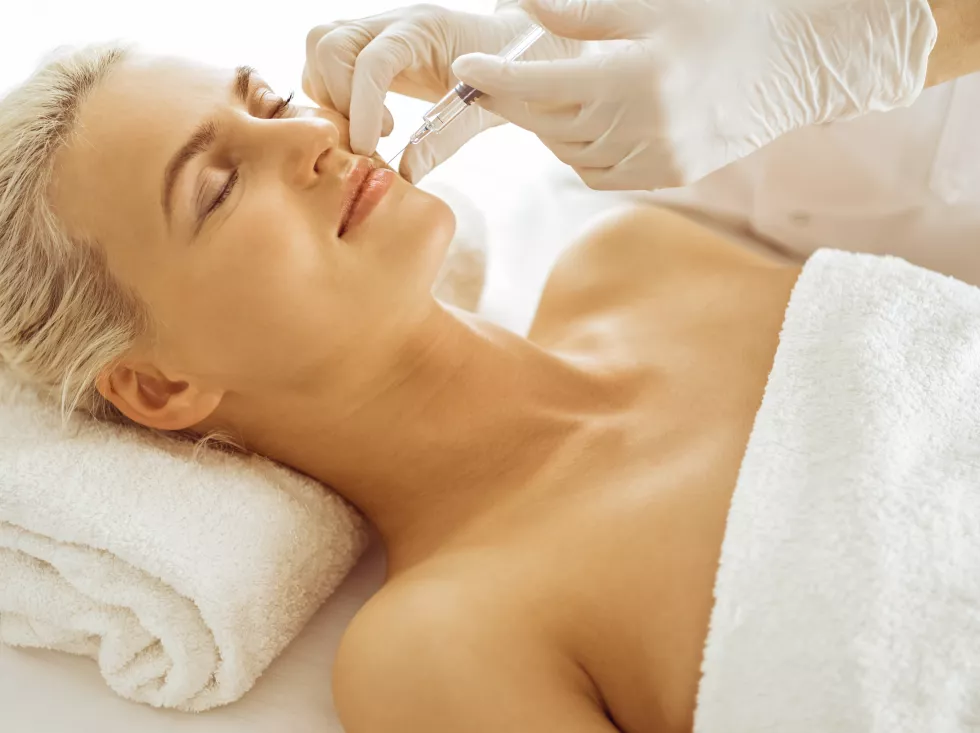 beautician-doctor-hands-doing-beauty-procedure-female-face-with-syringe-cosmetic-medicine-surgery-beauty-injections-concept