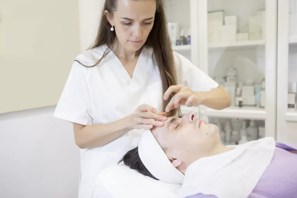 esthetician-performing-facial-massage-middle-aged-man-skin-care-concept