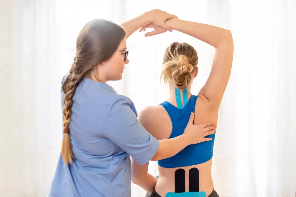 physical-therapist-examining-woman