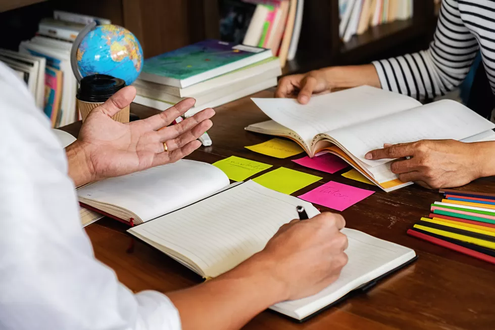 midsection-man-woman-studying-table