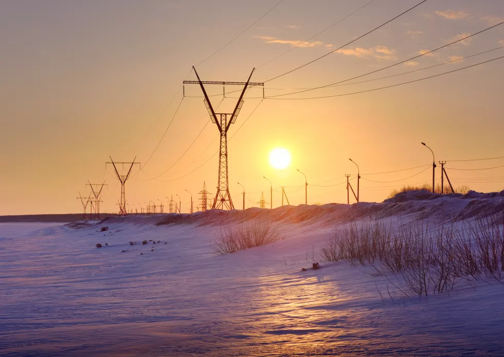 winter-sunset-ob-sea-power-line-poles-extending-into-distance