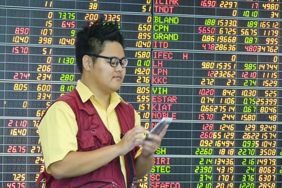 man-using-digital-tablet-by-stock-market-data