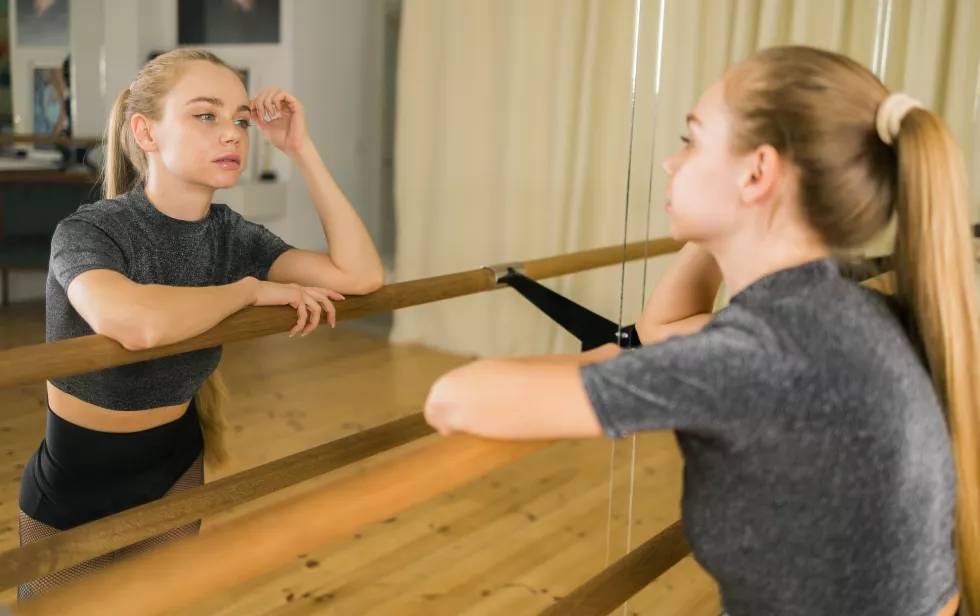 female-ballet-dancer-practicing-barre-dance-studio-dance-ballerina-concept