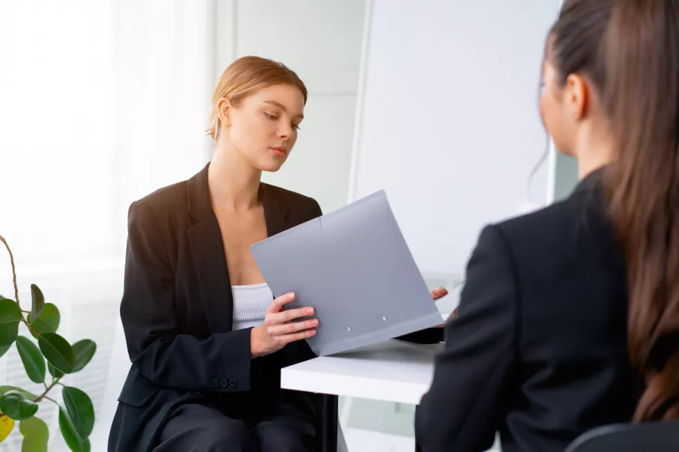 job-interview-business-career-placement-concept-young-blonde-woman-holding-resume-while-sitting-front-candidate-corporate-meeting-job-interview
