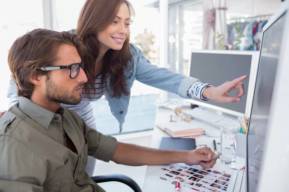 colleague-pointing-photo-out-editor