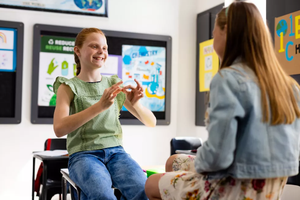 happy-diverse-schoolchildren-using-sign-language-school-classroom