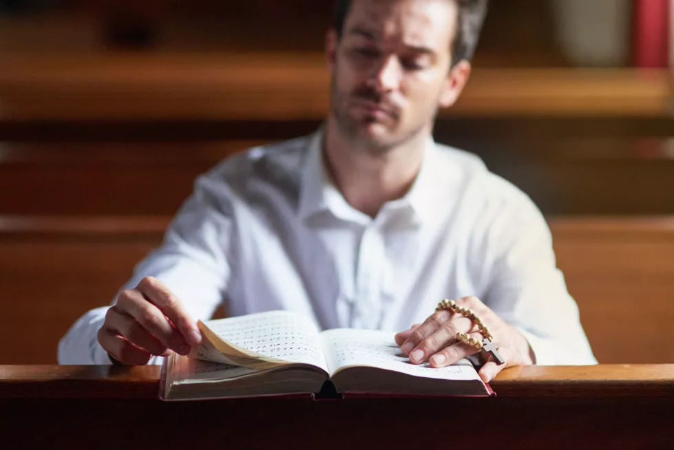 hearing-gods-voice-through-his-verse-shot-young-man-reading-bible-church