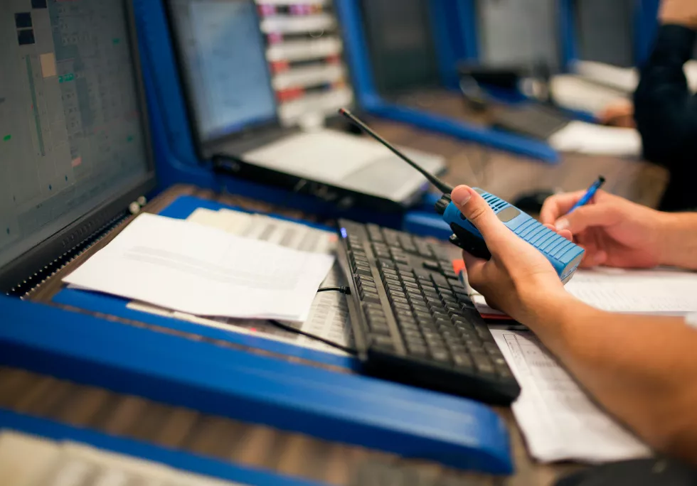 cropped-hands-engineer-with-walkie-talkie-by-computers-control-room
