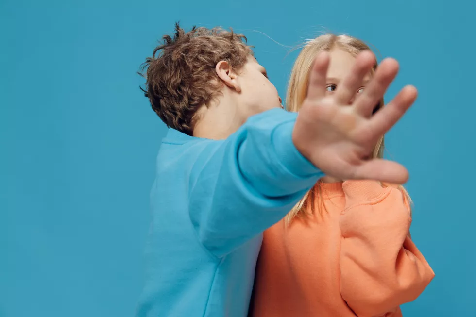 side-view-man-with-arms-crossed-against-blue-background