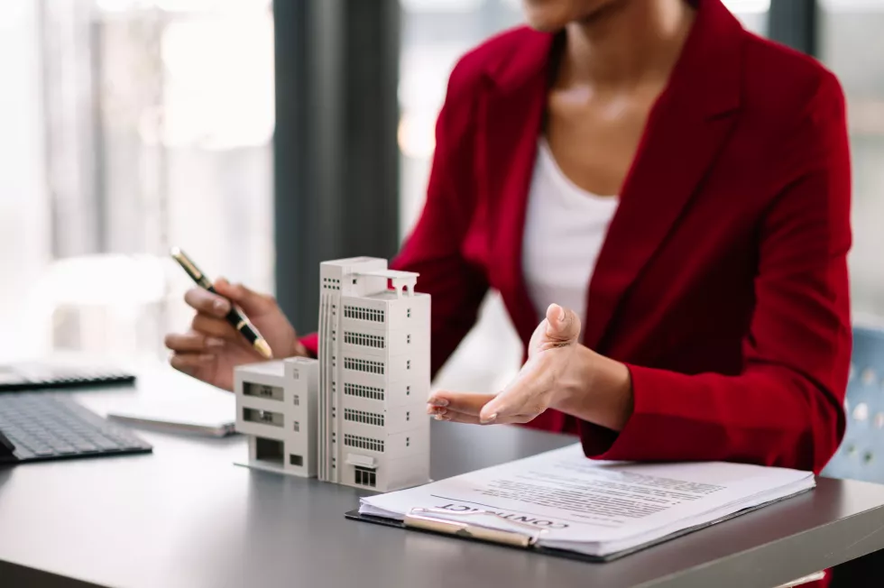 real-estate-broker-agent-presenting-consult-customer-decision-making-sign-insurance-form-agreement-home-model-concerning-mortgage-loan-offer-officexa