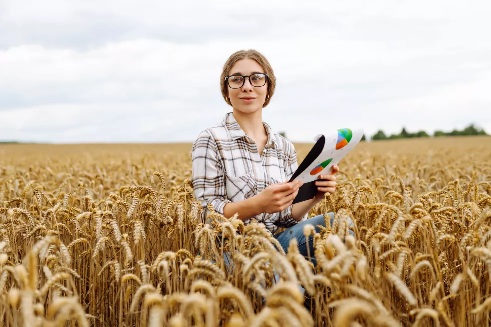 farmer-woman-watching-some-charts-checking-wheat-field-progress-agriculture-ecology-concept