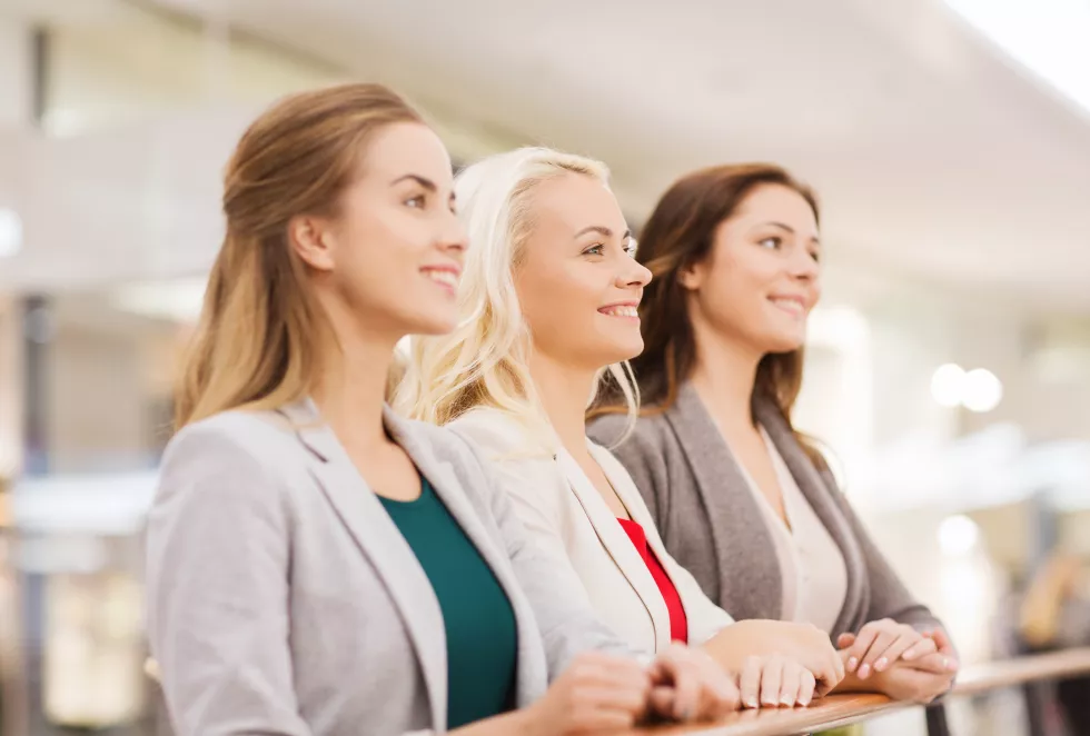 sale-consumerism-people-concept-happy-young-women-mall-business-center