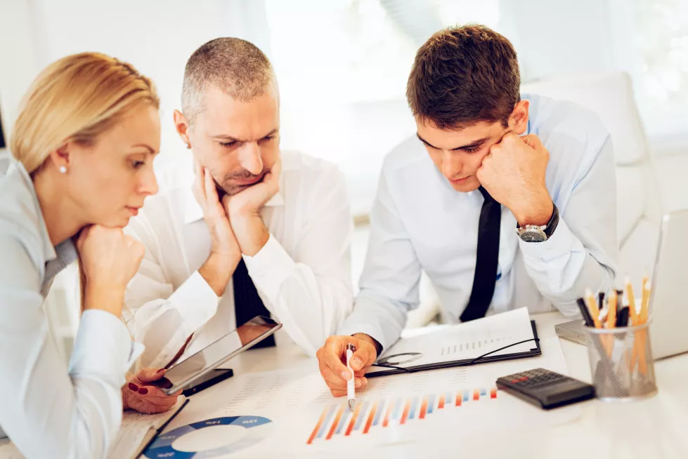 business-people-having-meeting-three-business-people-looking-document-discussing-office