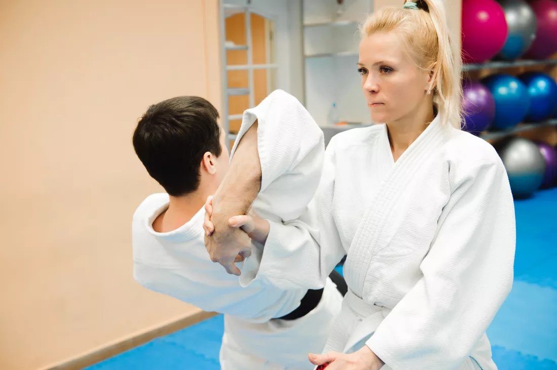 man-woman-fighting-aikido-training-martial-arts-school