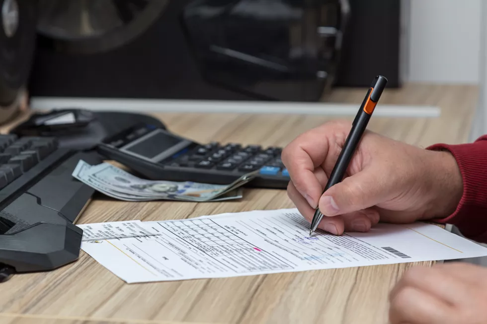 cropped-hands-man-writing-paper-table
