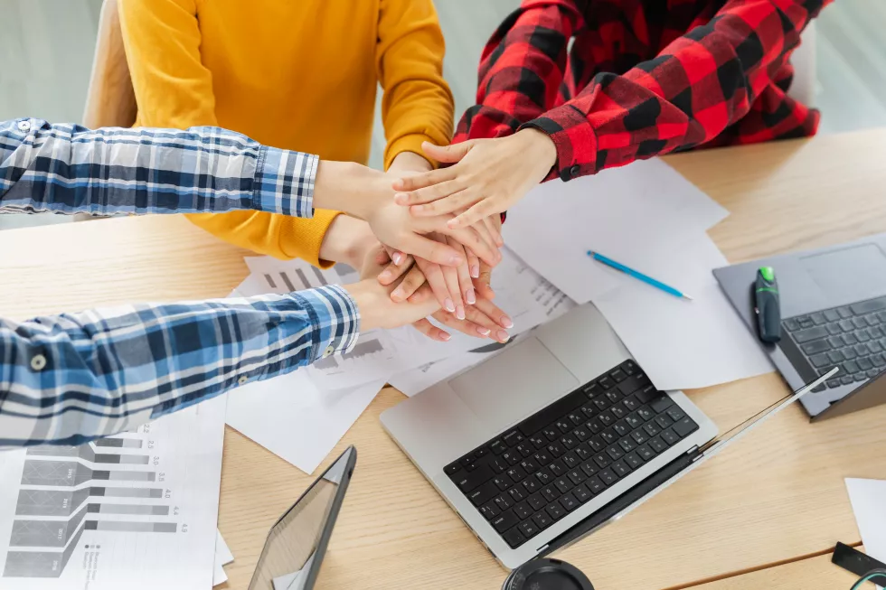 stack-hands-business-startup-teamwork-unity-concept-diverse-team-putting-their-hands-together-top