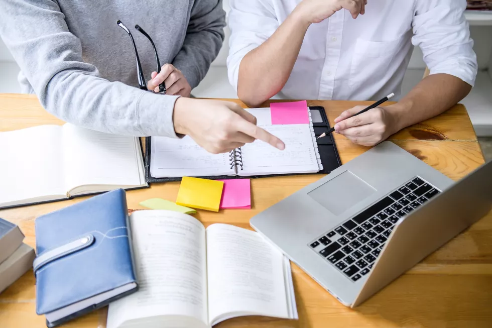 high-angle-view-student-pointing-laptop-table