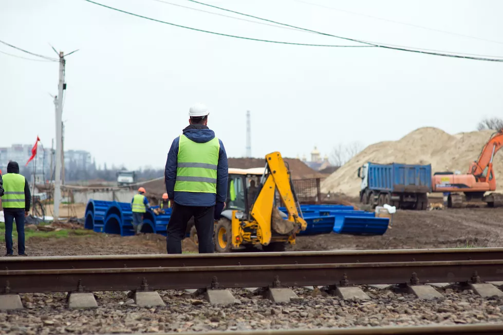 construction-manager-construction-site-with-excavator-construction-equipment-back-view