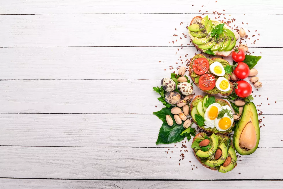 set-avocado-sandwiches-cherry-tomatoes-quail-eggs-chia-seeds-wooden-background-top-view-free-space-your-text