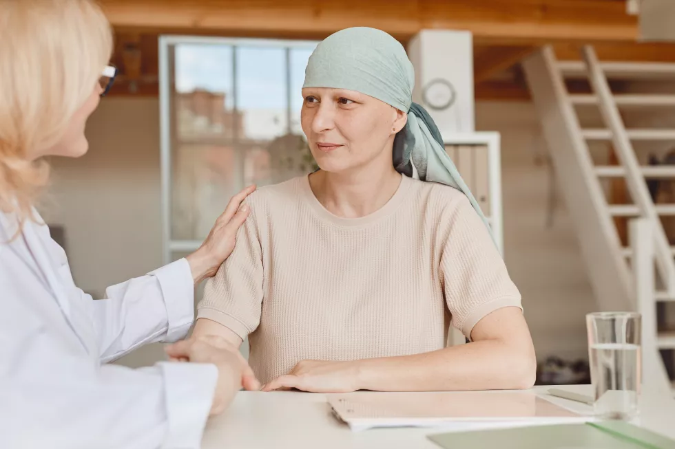 warm-toned-portrait-mature-bald-woman-talking-female-doctor-comforting-congratulating-her-consultation-alopecia-cancer-recovery-copy-space