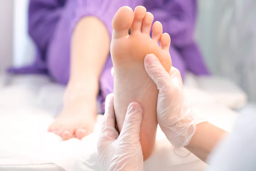 medical-pedicure-foot-massage-with-hands-transparent-gloves