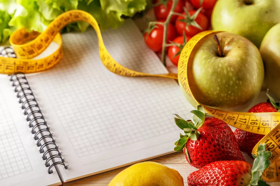fresh-organic-vegetables-fruits-open-blank-notebook-pen