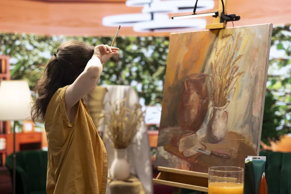 tired-woman-painter-finishing-her-creative-fine-art-piece-canvas