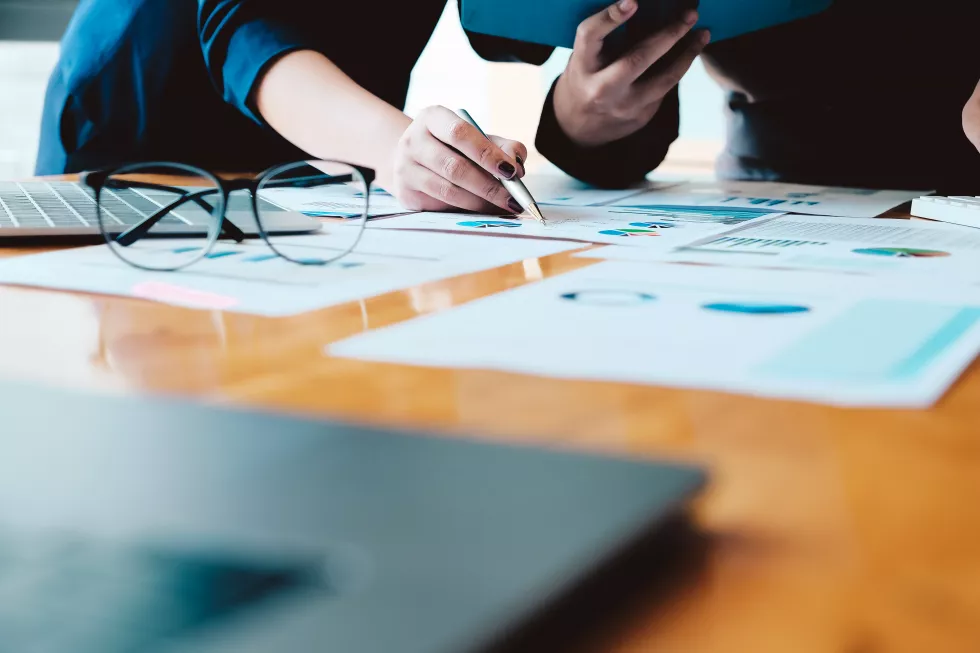 midsection-woman-using-mobile-phone-while-sitting-table