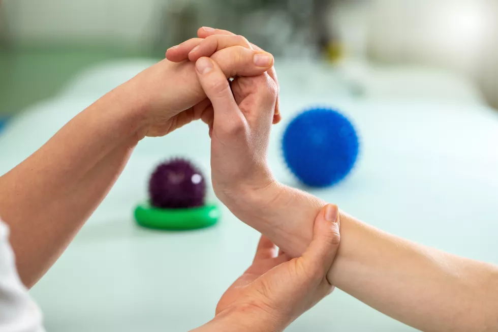doctor-exercising-making-rehabilitation-with-patient-wrist