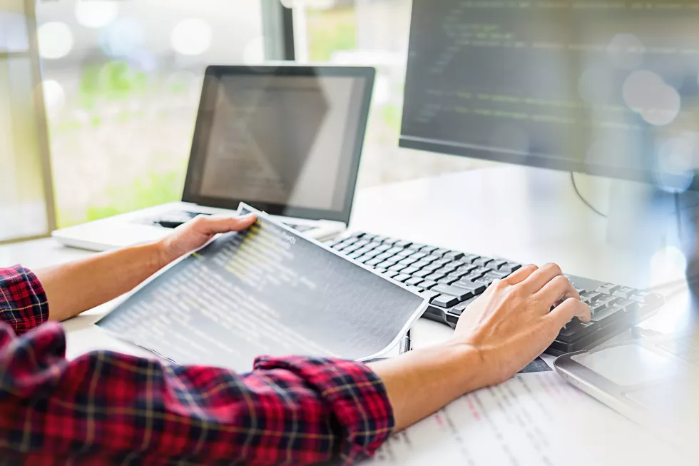 cropped-hands-businesswoman-using-computer-desk-office