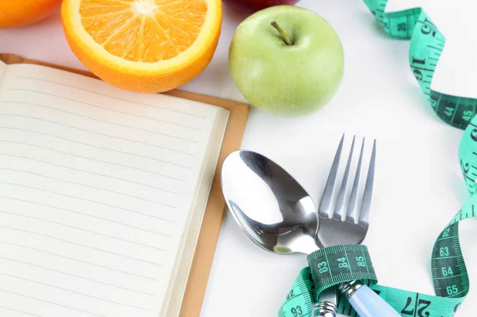 cutlery-tied-with-measuring-tape-book-with-fruit-close-up