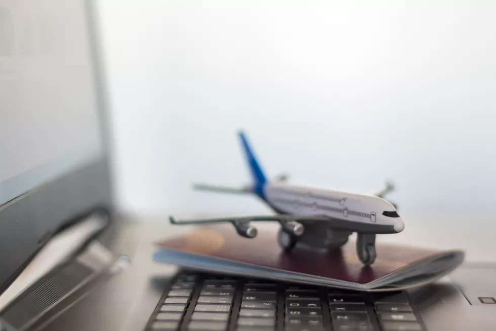 close-up-model-airplane-passport-laptop-table