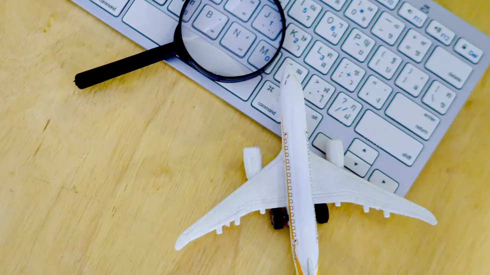 magnifying-glass-with-computer-keyboard-model-airplane-table