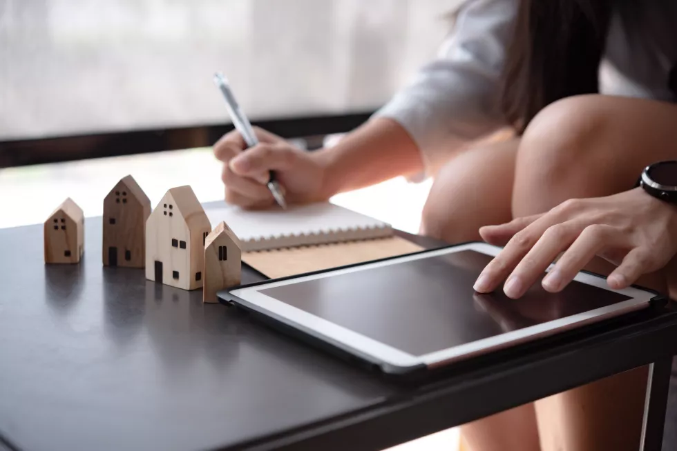 midsection-real-estate-agent-using-digital-tablet-table