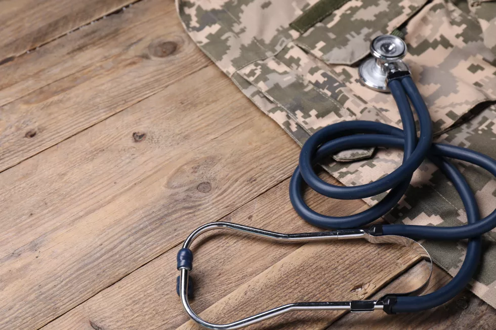stethoscope-military-uniform-wooden-table-space-text