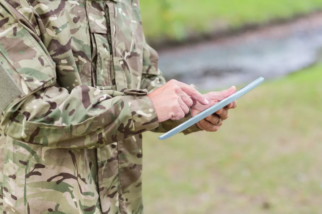 soldier-looking-tablet-pc-park