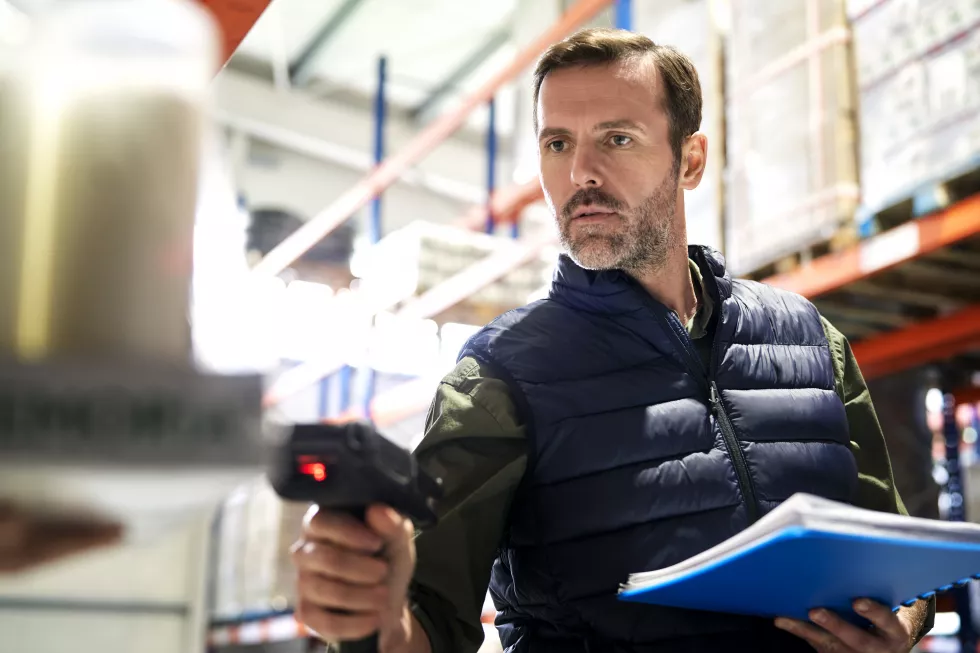 close-up-caucasian-man-using-bar-code-reader-warehouse
