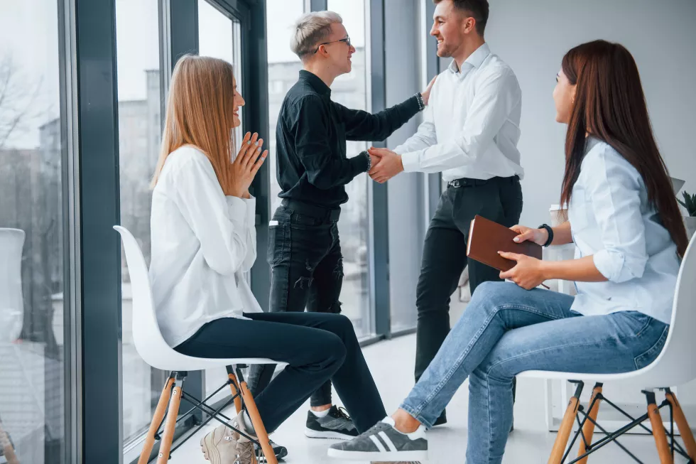 successful-agreement-doing-handshake-group-young-successful-team-that-working-communicating-together-indoors-office