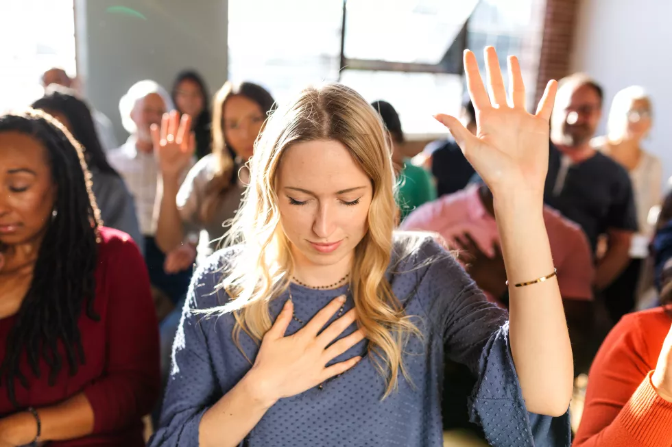 group-meditation-session-with-diverse-participants-support-group-woman-with-blonde-hair-raises-her-hand-focusing-meditation-meditation-focus-diverse-group-support-group
