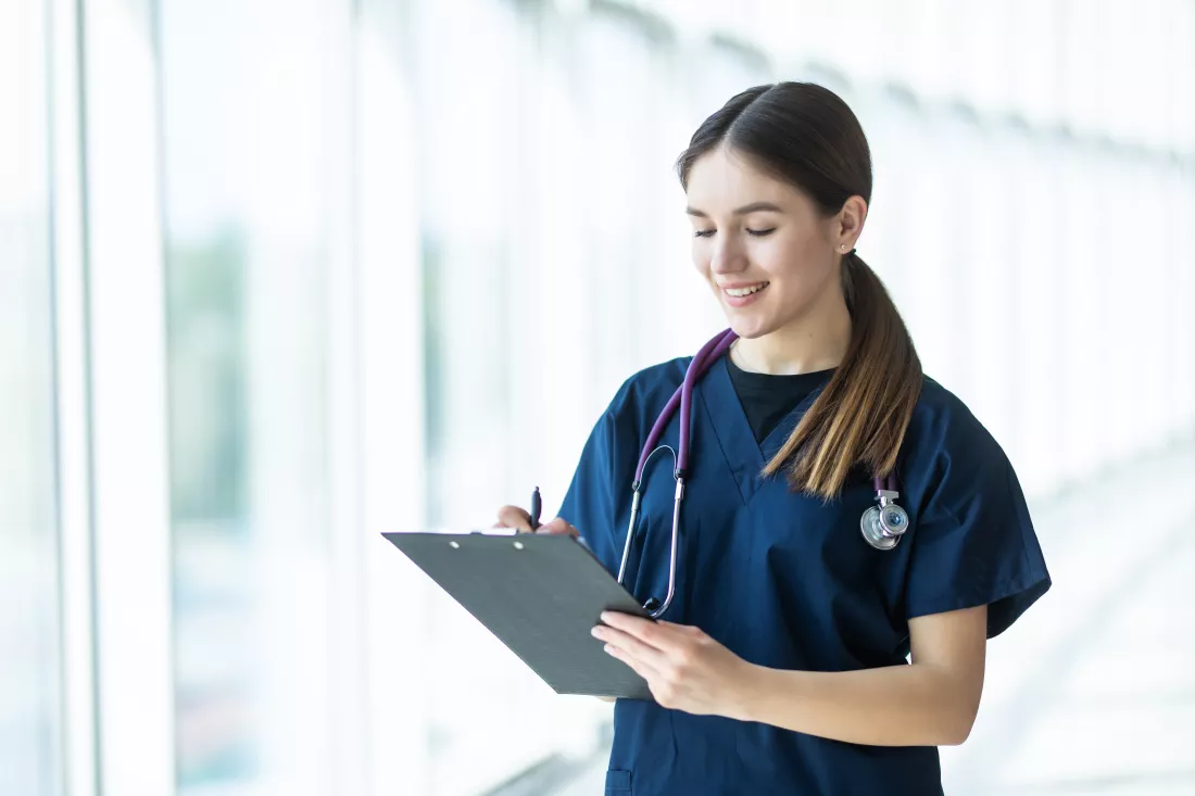 smiling-young-female-doctor-holding-clipboard-hospital