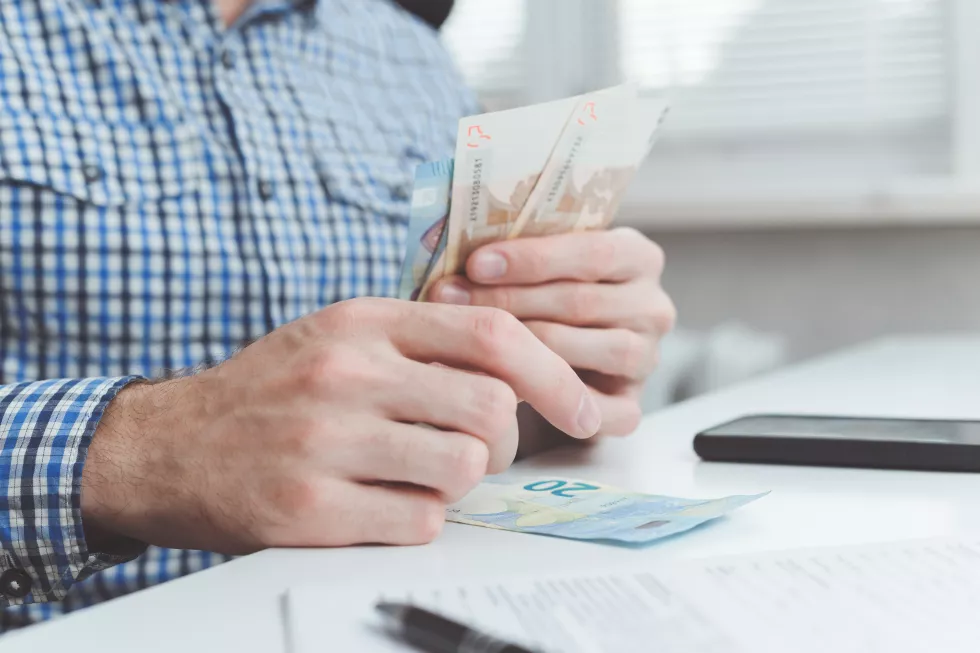 midsection-man-holding-paper-with-text-table