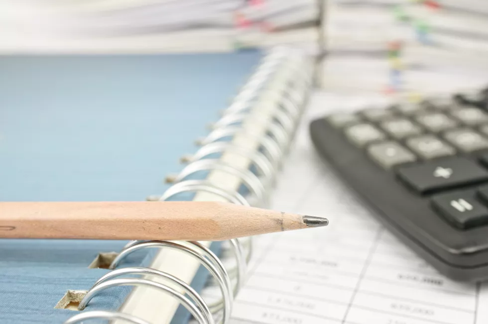 close-up-pencil-book-by-calculator-table-office