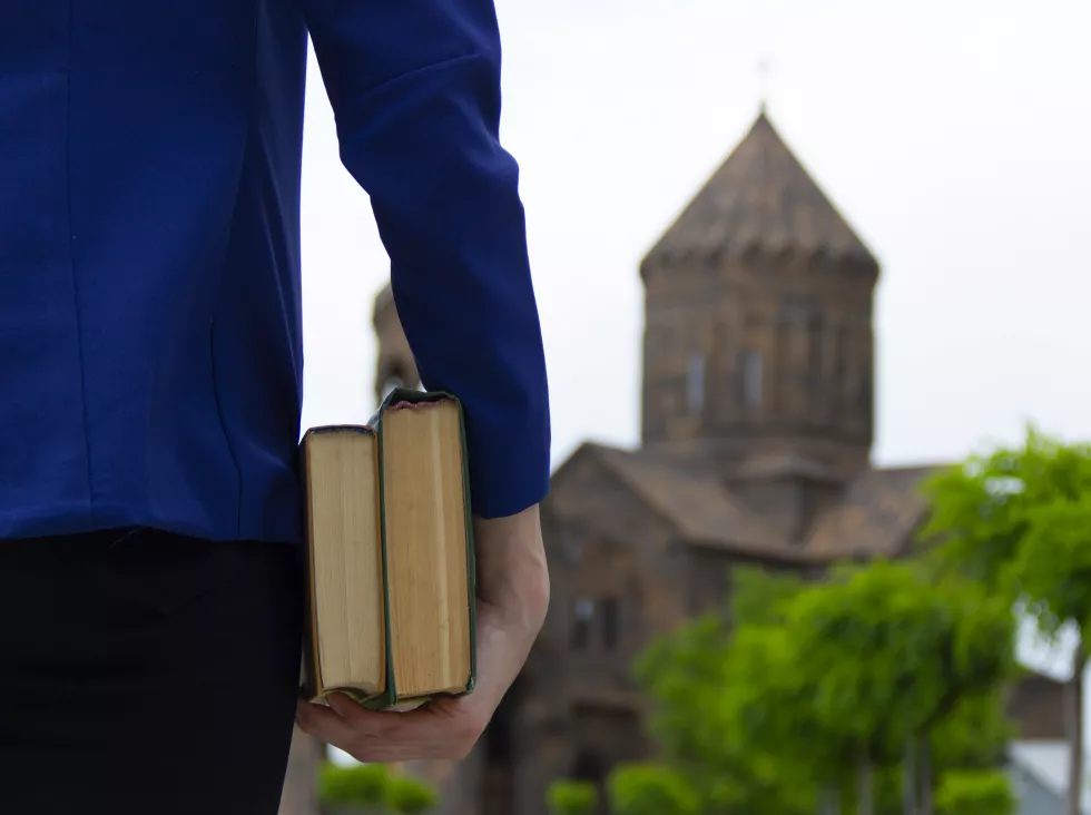 young-woman-looks-church-holding-books-her-hand