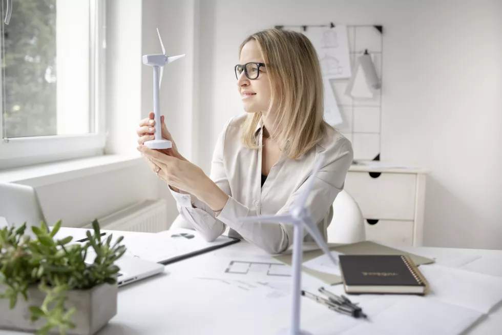 woman-using-mobile-phone-while-sitting-table