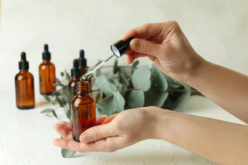 concept-natural-cosmetics-with-female-hand-dripping-eucalyptus-oil